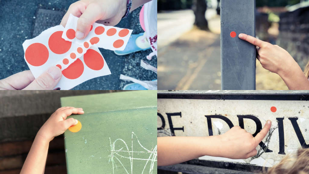 A selection of street signs with sticky dots on them.